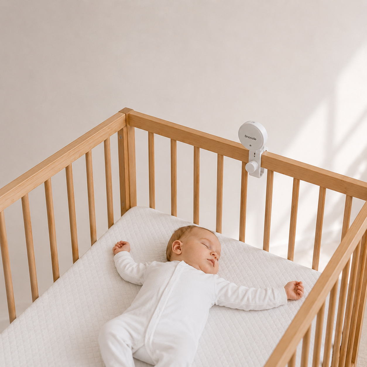 Snoozie monitor watching over a baby sleeping in a cot